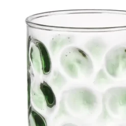 Glas met groene stippen